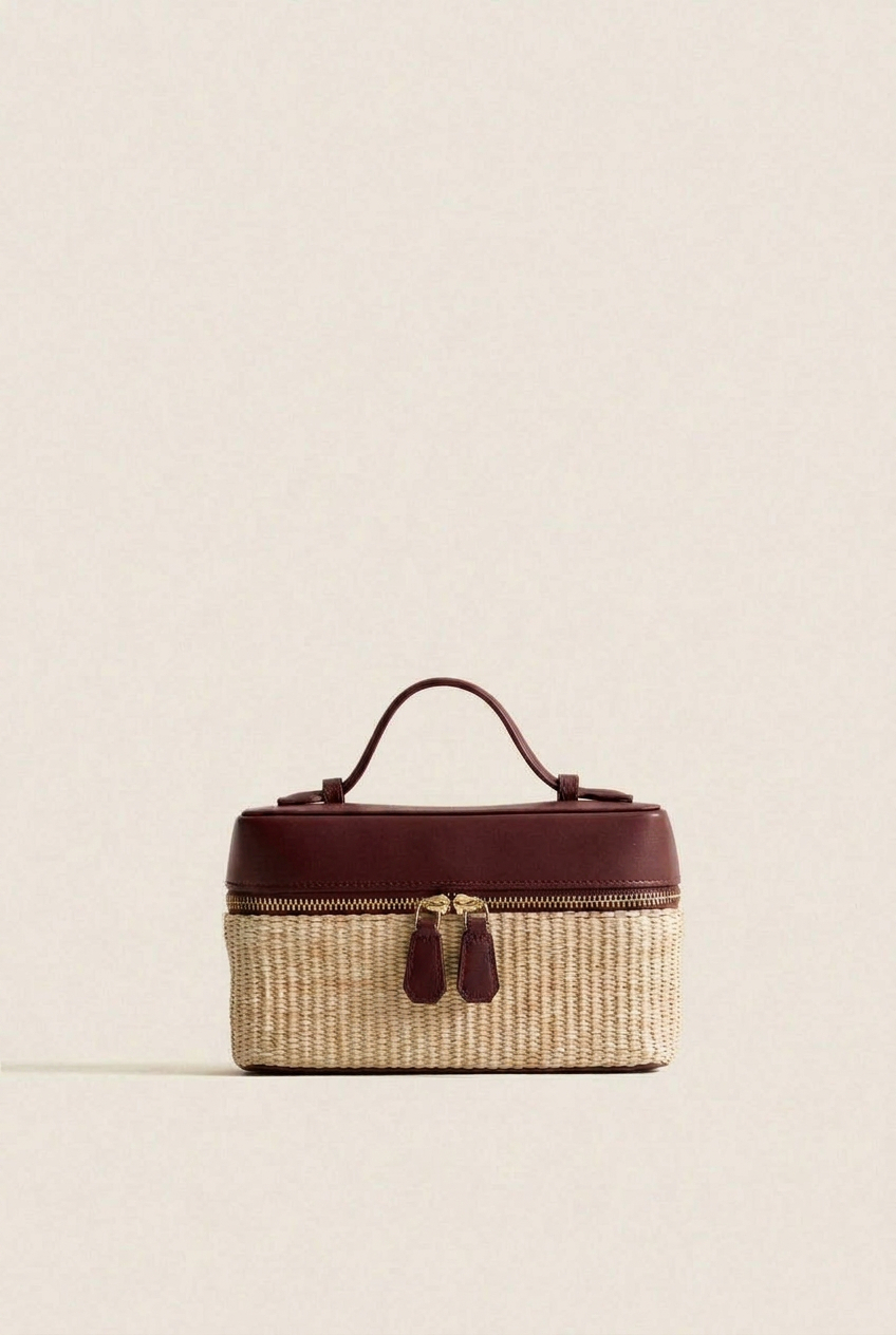 Mixed material vanity case with woven raffia body and burgundy leather top with gold zip